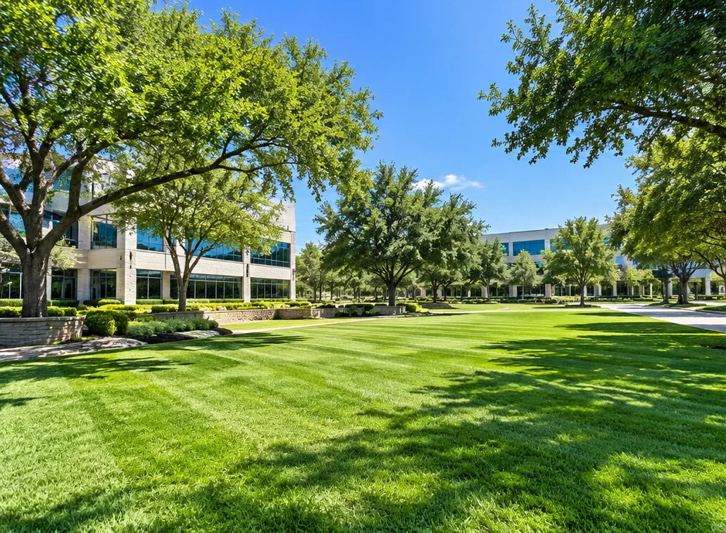 Illustrative commercial campus landscape with manicured lawns and mature trees